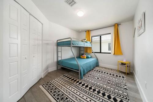 a bedroom with a bunk bed and a rug at Modern RocknHome Near Hard Rock and FLL Airport in Fort Lauderdale