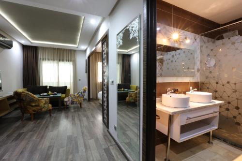 a bathroom with two sinks and a large mirror at Silver Suites Hotel Casablanca in Casablanca