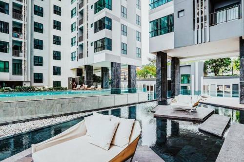 an apartment patio with a pool and a building at Sea View 2 Bed Room Condo @ Central Pattaya in Pattaya Central