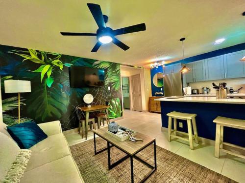 a living room with a couch and a ceiling fan at The Amazon at Holiday Park near Las Olas Beach in Fort Lauderdale