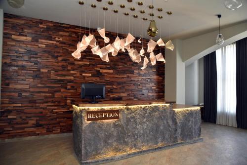 a lobby with a brick wall and a reception desk at Цахкадзор кечи аус Уютное студио с видом на лес - Cozy studio with stunning forest views in Tsaghkadzor