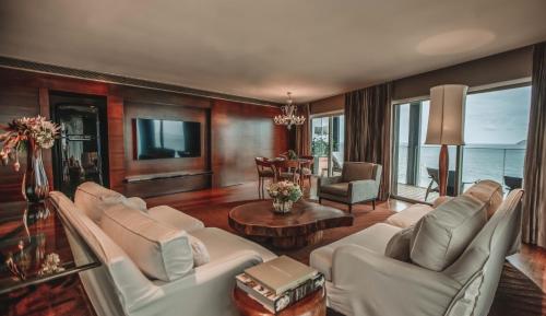 a living room with two white couches and a table at Hotel Fasano Rio de Janeiro in Rio de Janeiro