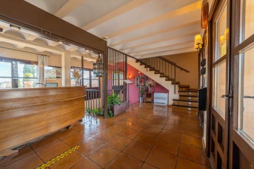 a hallway of a building with a bench and stairs at Cigarral de Caravantes in Toledo