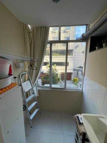 a small kitchen with a ladder in front of a window at Rio de Janeiro Botafogo Zona Sul in Rio de Janeiro