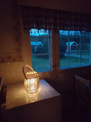 a basket sitting on a table in front of a window at Wild nature in Kuhmo