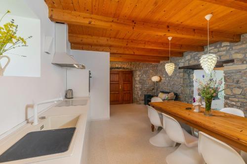 a kitchen and dining room with a stone wall at Sussini in Potpićan