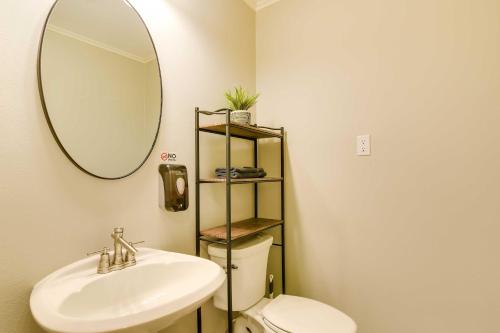 a bathroom with a sink and a mirror and a toilet at Indoor Pool Peaceful Oasis in Hitchcock! in Hitchcock