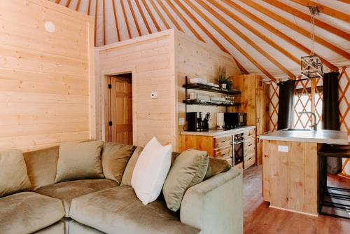 ein Wohnzimmer mit einem Sofa in einer Hütte in der Unterkunft Junaluska @ Sky Ridge Yurts in Bryson City