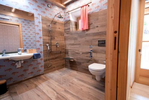 a bathroom with a toilet and a shower and a sink at Haus Himmelfahrt in Soprabolzano