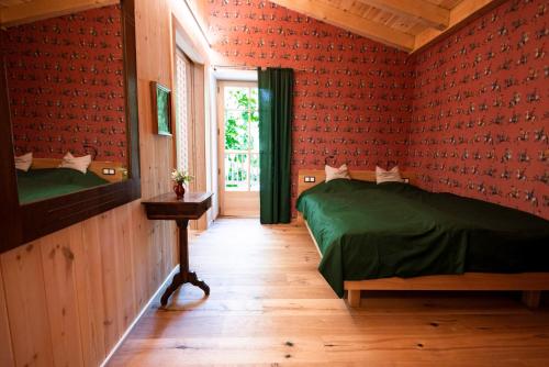 a bedroom with red walls with two beds and a window at Haus Himmelfahrt in Soprabolzano