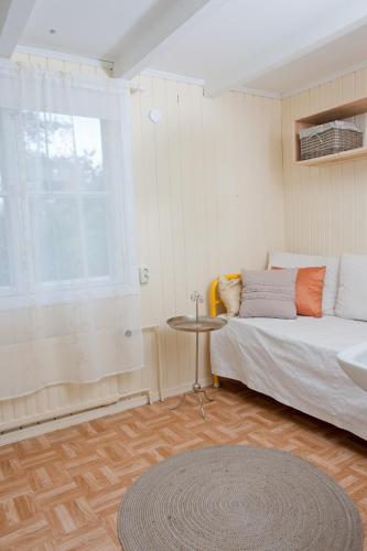 a bedroom with a bed and a table and a window at Soltorp Eco Lodge in Porvoo