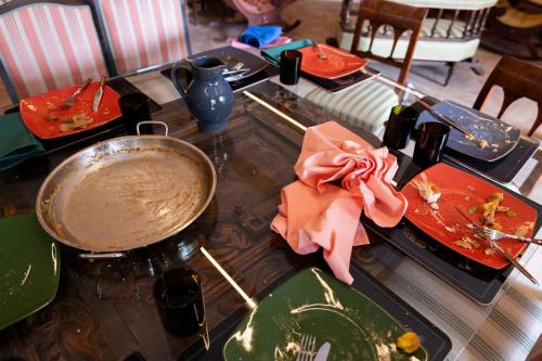 a table with plates of food and a pan on it at Haus Himmelfahrt in Soprabolzano