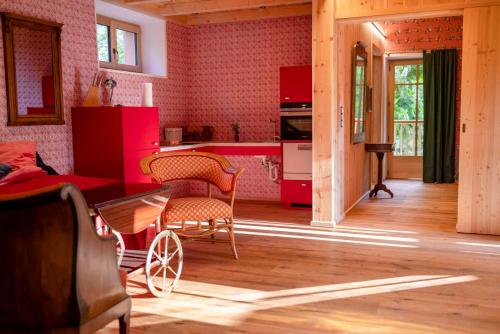 a kitchen with red cabinets and a table and chairs at Haus Himmelfahrt in Soprabolzano