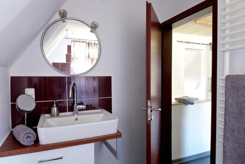 a bathroom with a sink and a mirror at FeWo Birkenweg in Schneverdingen