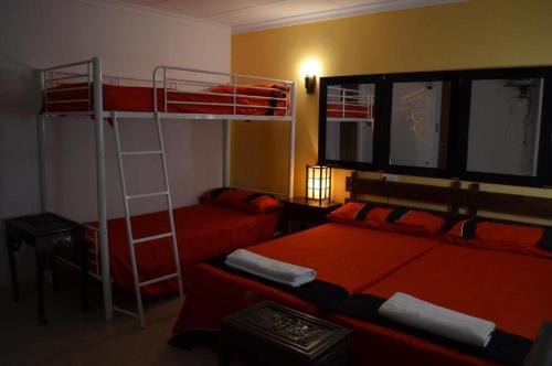a bedroom with two bunk beds and a ladder at Santiago Mallorca in Cala Figuera
