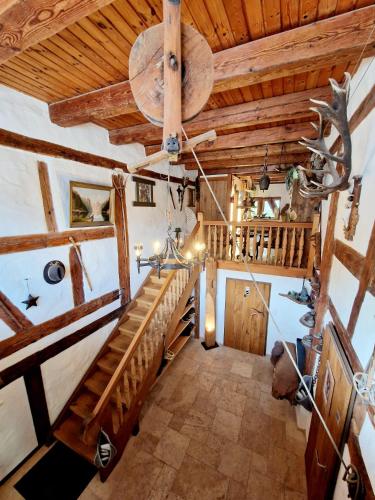 an attic room with a staircase and wooden ceilings at Wood & Stone Lodge 3 in Donaueschingen