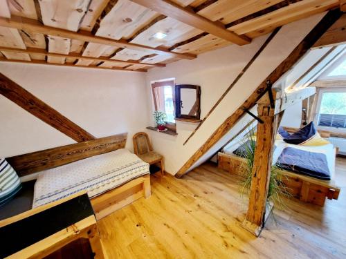 a attic room with two beds and a staircase at Wood & Stone Lodge 3 in Donaueschingen