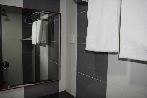 a bathroom with a shower and a mirror at Hotel Sri Garden Sdn. Bhd. in Kangar