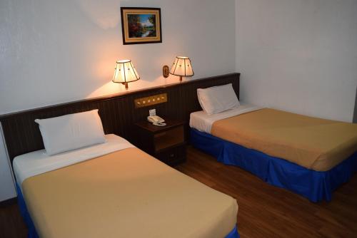 Кровать или кровати в номере Hotel Sri Garden Sdn. Bhd.