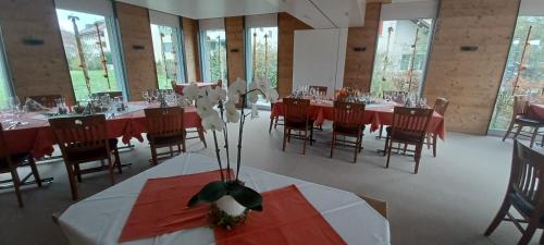 a dining room with tables and chairs with red tablecloths at Hotel / Restaurant Post in Eschlikon
