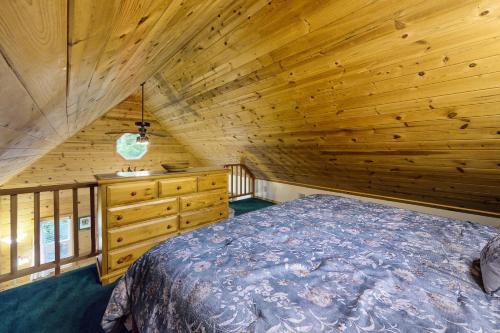 a bedroom with a bed and a wooden ceiling at Christina Cabin in Girdwood