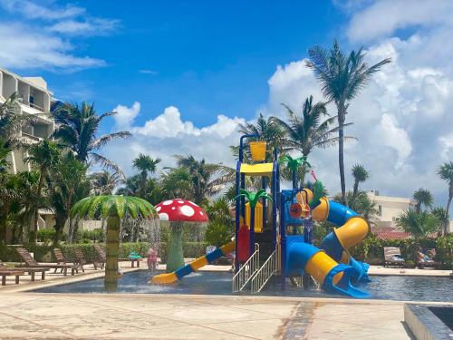 a playground in a pool with a water slide at Solymar Condos in Cancún