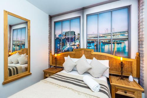 una camera da letto con un letto e una grande finestra di Mala Vecindad Beer Hotel a Città del Messico