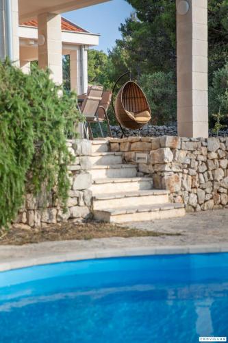 a set of stairs with a tub sitting on top of a house at Sonia Hvar in Rudina