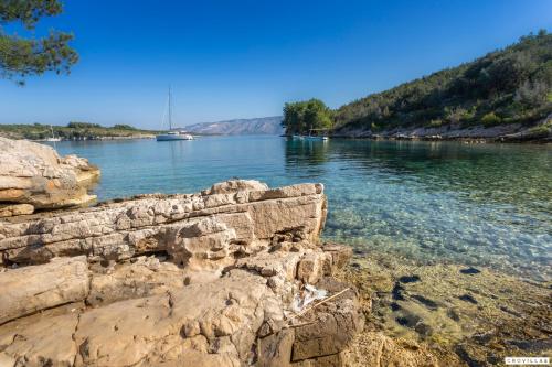 a view of a river with a boat in the water at Sonia Hvar in Rudina
