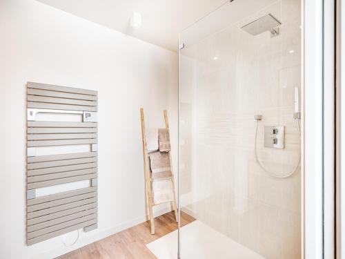 a bathroom with a shower and a glass door at Cottage B10 in Koksijde