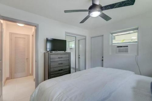 a bedroom with a bed and a ceiling fan at SuaveMauve Las Olas Beach in Fort Lauderdale