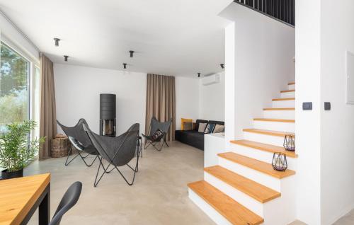 a house with white walls and wooden stairs at Green Zebra in Fuškulin