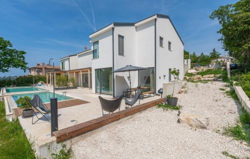 a home with a swimming pool and a house at Green Zebra in Fuškulin