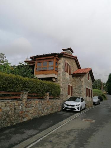 a white car parked in front of a house at Casa Bonita in Mugardos