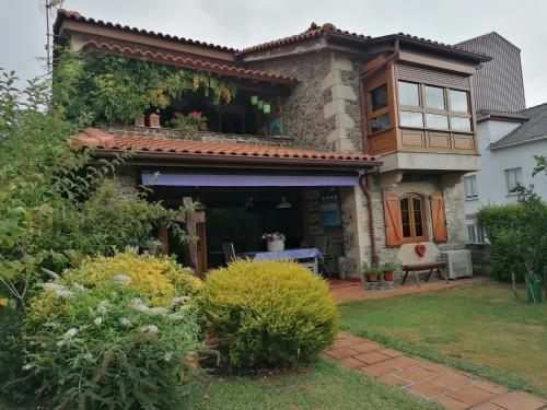 a house with a porch and a patio at Casa Bonita in Mugardos