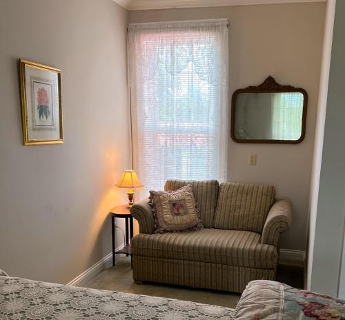 a living room with a couch and a window at Rocky Hill Inn in Smiths Grove