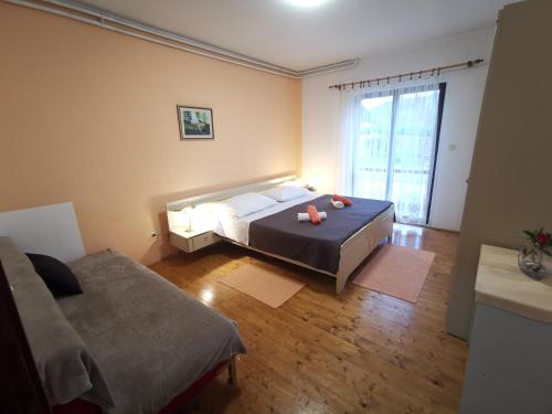 a bedroom with a bed and a large window at Apartment Feruco in Kršan