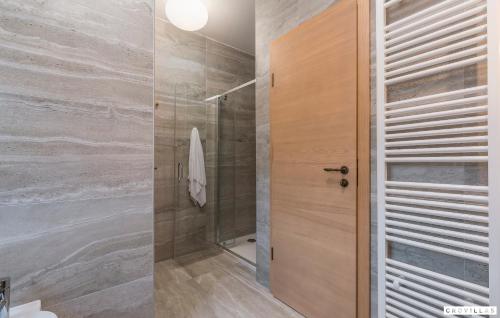 a bathroom with a shower and a glass door at Provence in Vilanija
