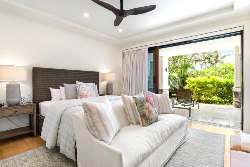 a bedroom with a white bed and a white couch at K B M Resorts Montage Residence Pama 2206 Stunning Groundfloor 3 bed Perfect for Families Easy pool access LOccitane Amenities in Kapalua