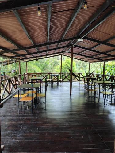 a group of tables and chairs in a pavilion at Bahareque Hostal in Ibagué