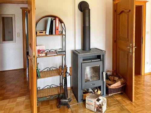a wood stove in a room with a doorway at Ferienwohnung zum Entspannen in Thalgau