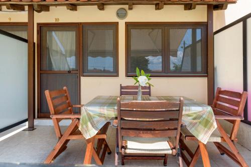 a table and chairs on a screened porch with a table and chairsktop at Panorama Studios in Ierissos