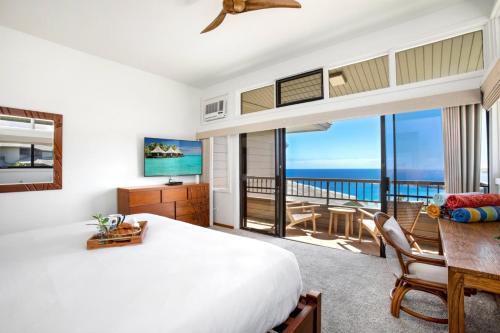 a bedroom with a bed and a view of the ocean at K B M Resorts- KRV-2823 Large 1Bd with 180-degree ocean views perfect for whale watching in Kaanapali