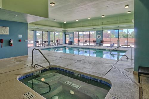 a large indoor pool with a hot tub in a building at Holiday Inn Express & Suites Albuquerque Historic Old Town by IHG in Albuquerque