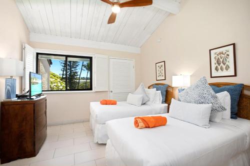 a living room with two white beds and a window at K B M Resorts Napili Villa C31 Ocean Front 2BDRM in Kapalua