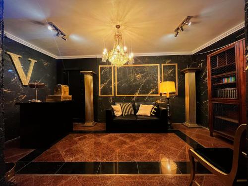 a living room with a couch and a chandelier at Alojamento VINTAGE BAIXA - TOMAR in Tomar
