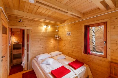 a bedroom with a bed in a wooden room at Siedlisko Carownica Family & Wellness in Lechów