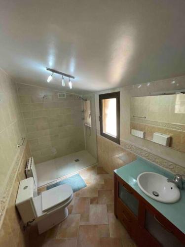 a bathroom with a white toilet and a sink at Casa Estrella in El Dondo