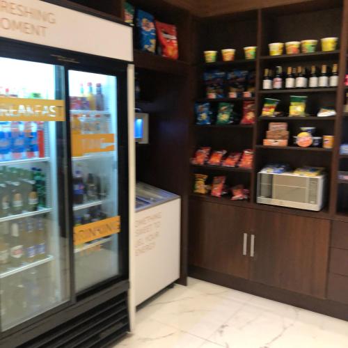 a store aisle with a refrigerator and shelves of food at Courtyard by Marriott Guayaquil in Guayaquil