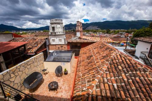 an aerial view of roofs of buildings with a clock tower at Casa Don Pedro Faro in San Cristóbal de Las Casas